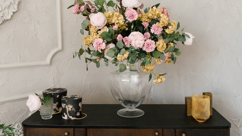 dresser with large bouquet of flowers