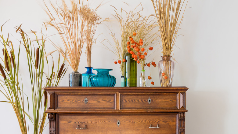 a dresser with dried florals