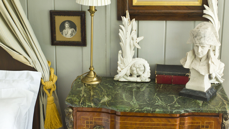 marble-topped dresser with white sculptures