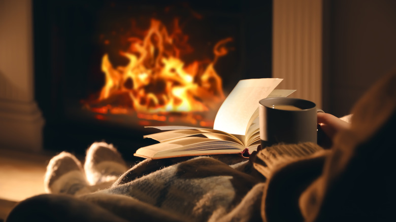person with book and fire
