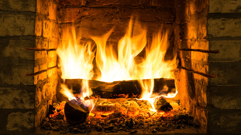 brick fireplace with flames