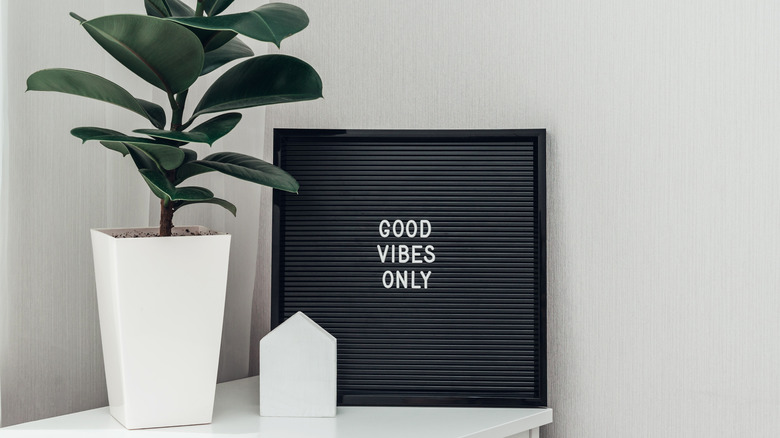 black letterboard next to houseplant