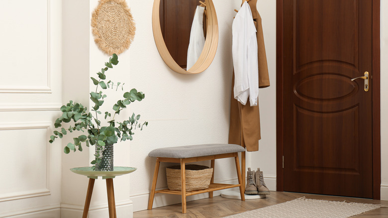 hallway foyer with round mirror