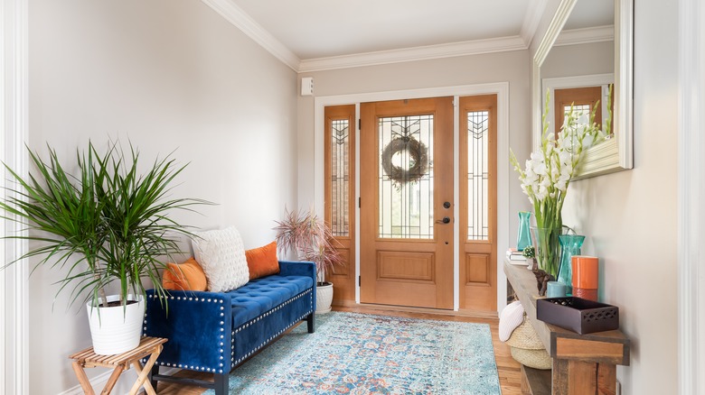 foyer with blue velvet bench