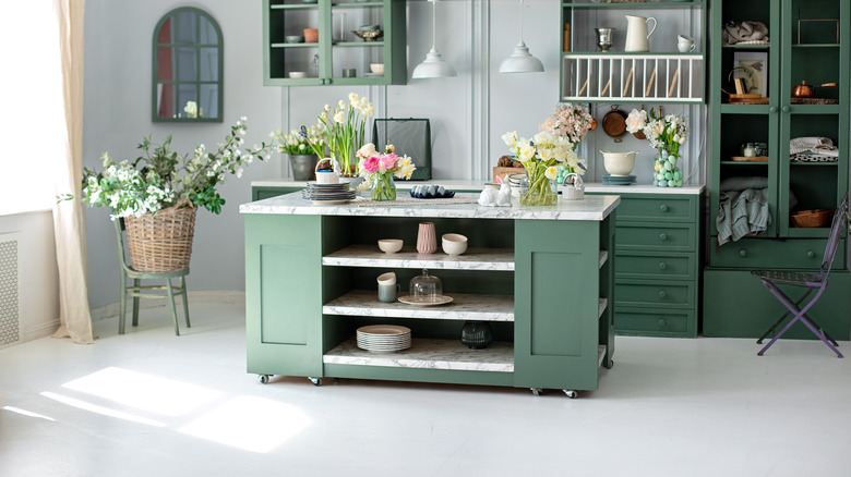 green kitchen island with flowers 