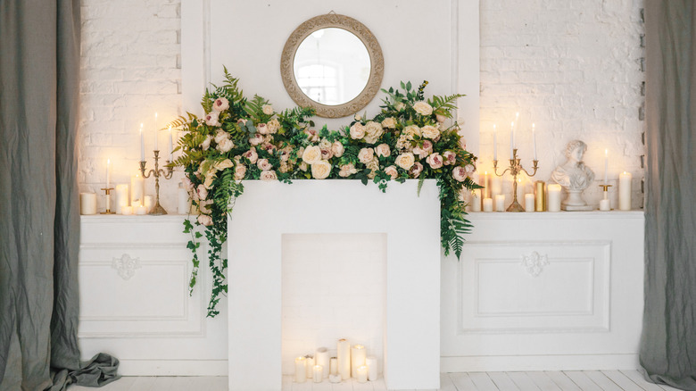 mantel with flowers and a mirror