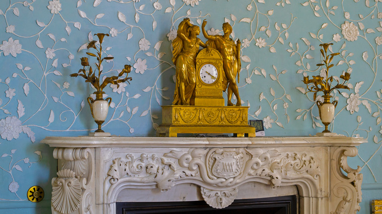 An ornate clock on a mantel