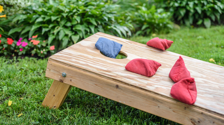 cornhole game board in yard