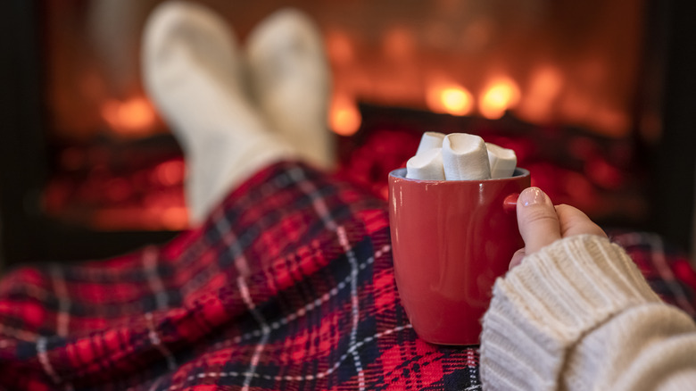 person relaxing with red blanket