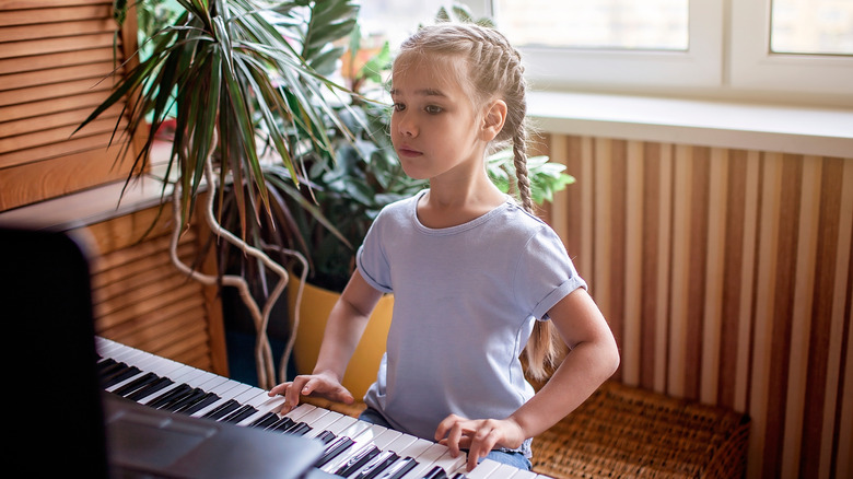 Young girl plays piano