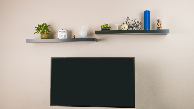 floating shelves hanging over television