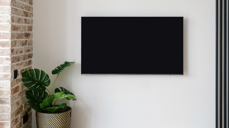 television hanging on white wall