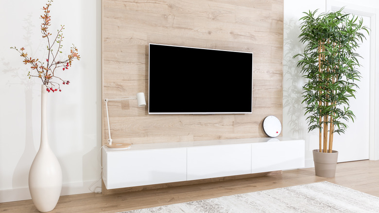 television on wood accent wall