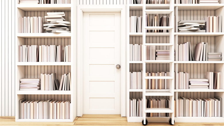 white library wall with a ladder