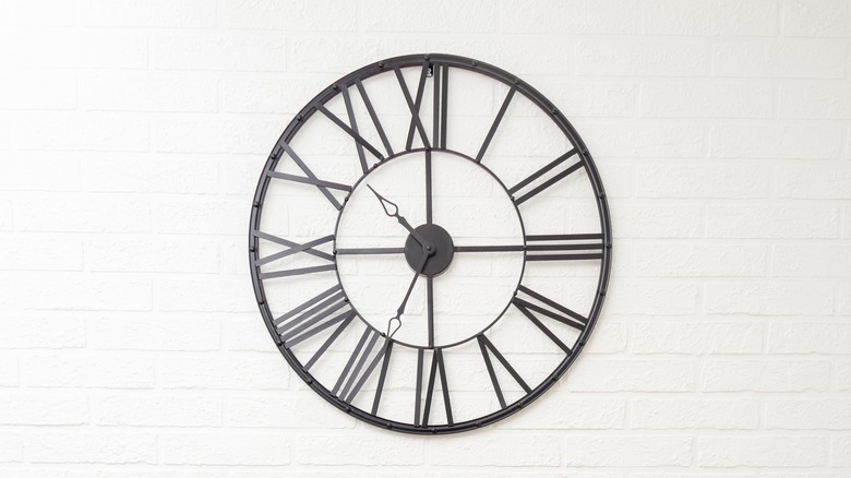 oversized black clock with Roman numerals