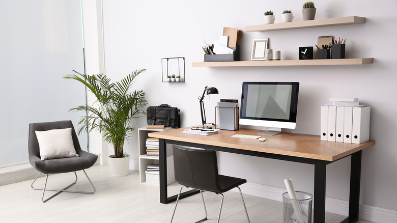 desk area with wall shelves