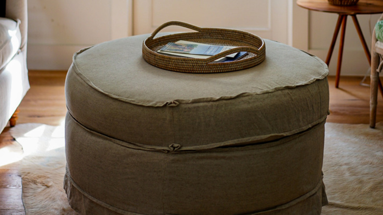 woven tray on beige ottoman 