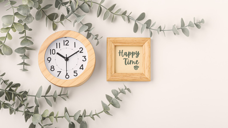 inspirational phrase and wall clock