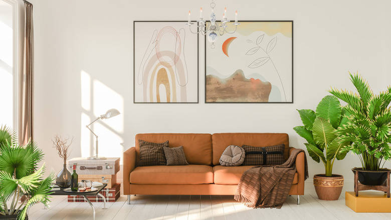 Living room with sofa, plants and wall art