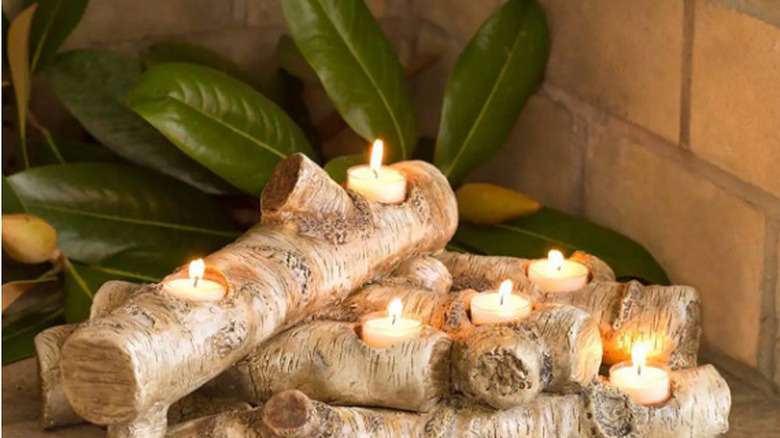 logs with votive candles inside