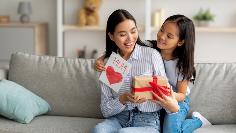 mom and daughter with greeting card