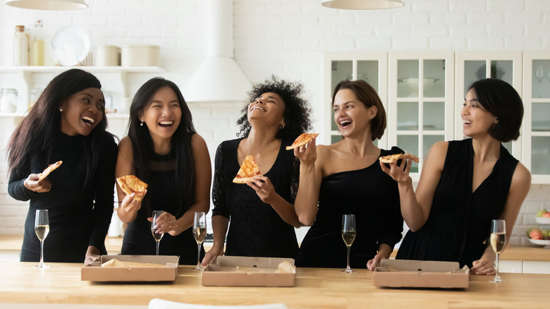 ladies having pizza in kitchen