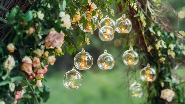 Glass candle holders in trees