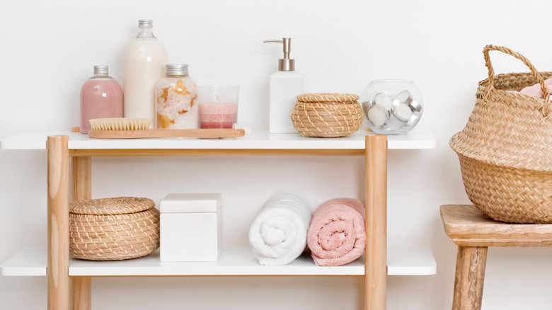 a bathroom shelf with rattan baskets