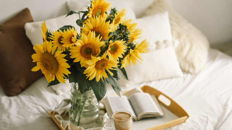 sunflowers on tray in bed