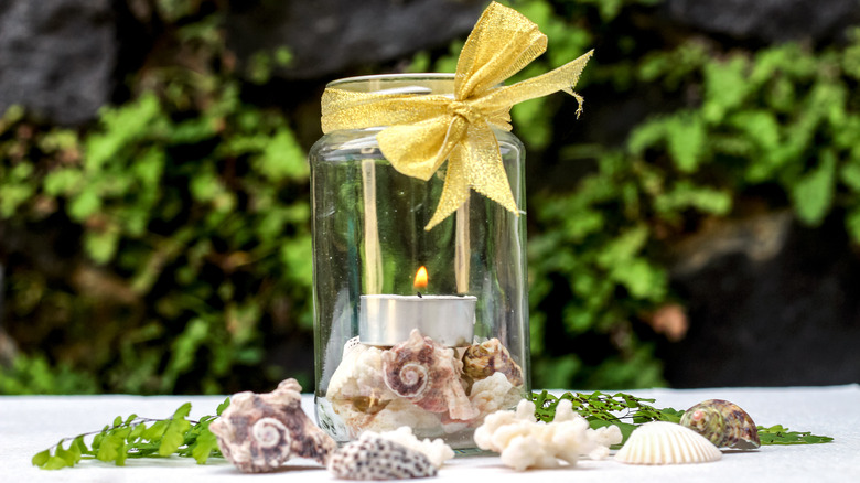 seashells and candle in mason jar