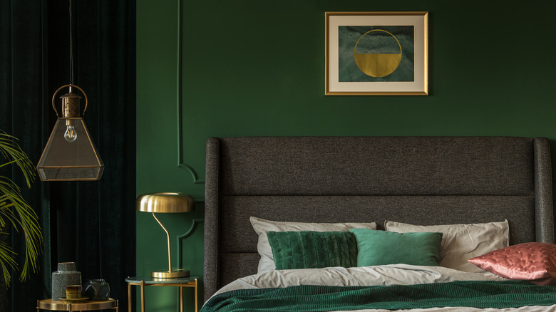 Green statement bedroom with art