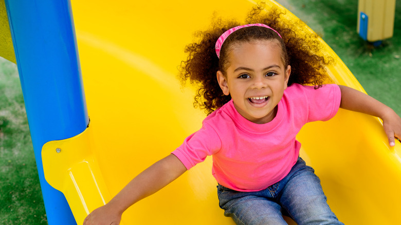 girl with pink shirt yellow slide