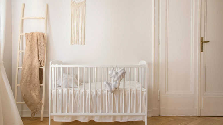 white minimalist nursery with crib