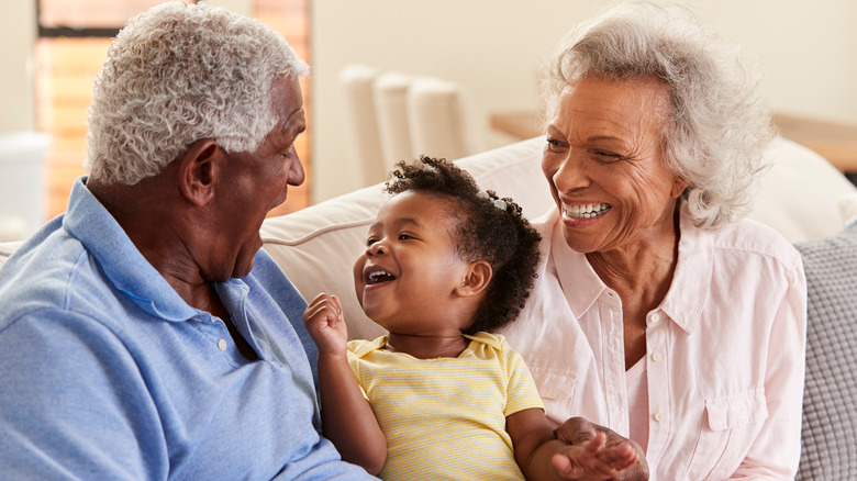 grandparents on couch with baby