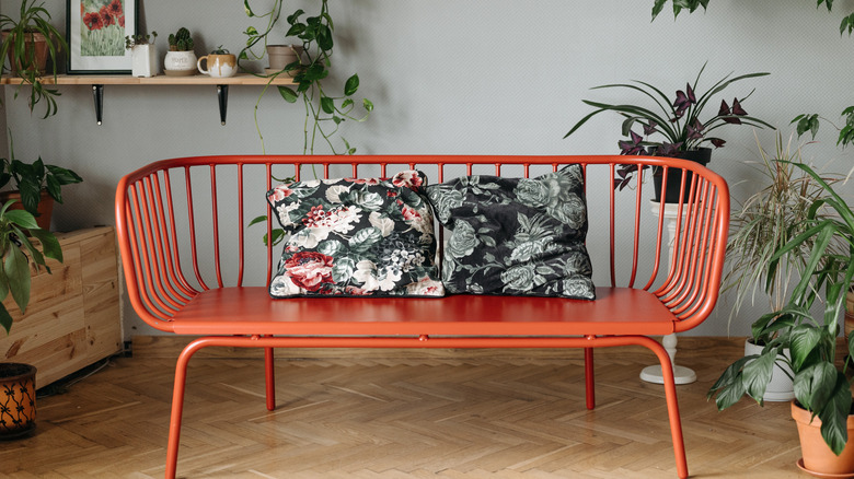 orange metal couch with plants