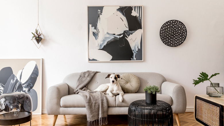 Abstract artwork behind gray couch