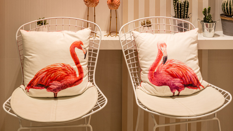 flamingo pillows on chairs