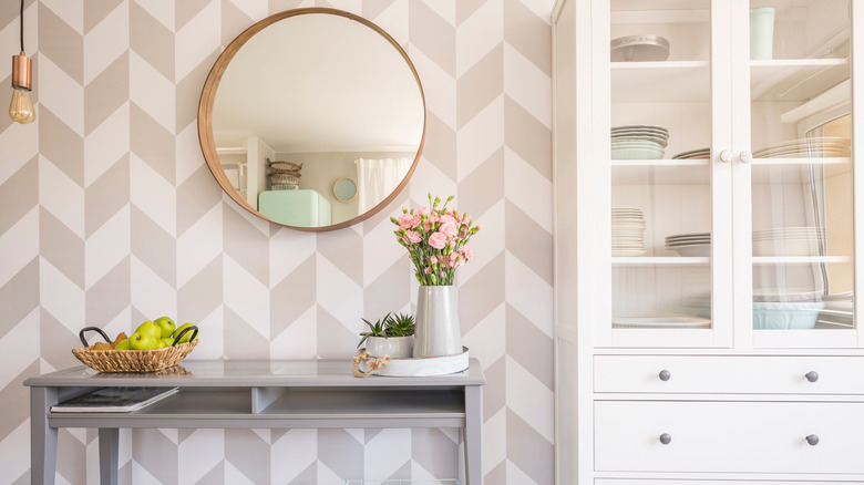 round mirror on wallpaper