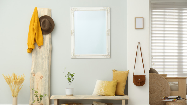 white rectangular mirror above bench 