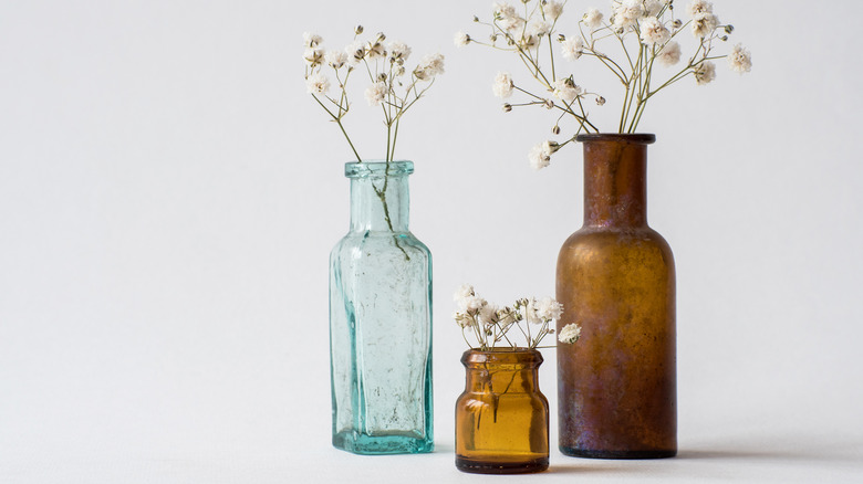 glass bottles with dried flowers