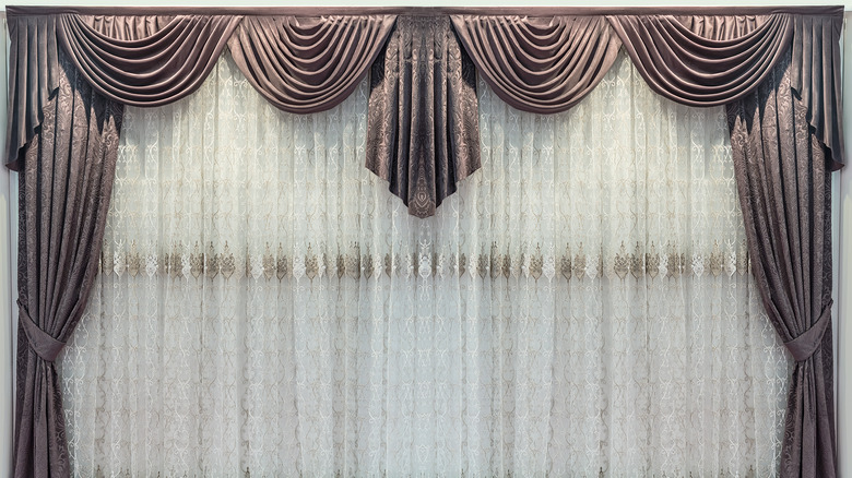 long pleated curtains on window