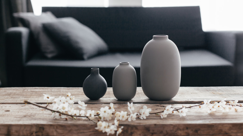 three different size gray vases