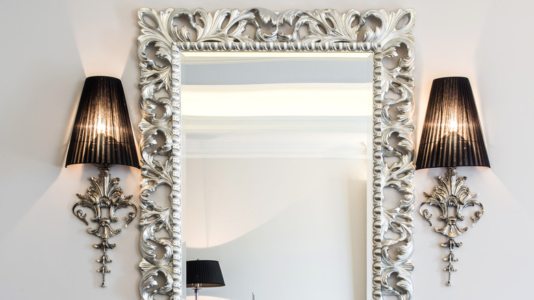 two wall sconces around mirror