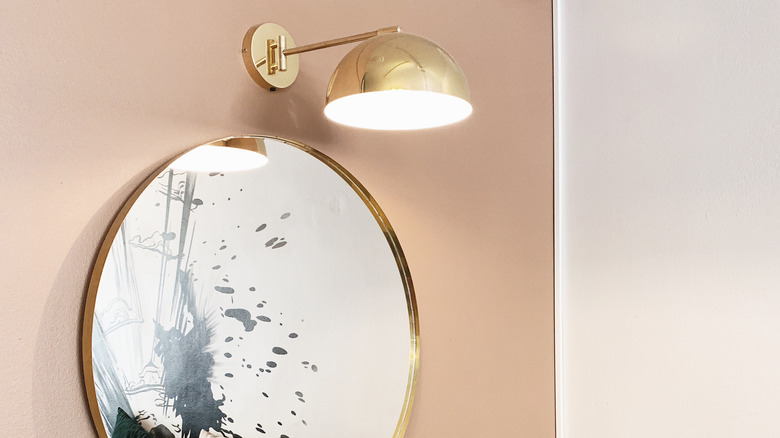 wall sconce above mirror