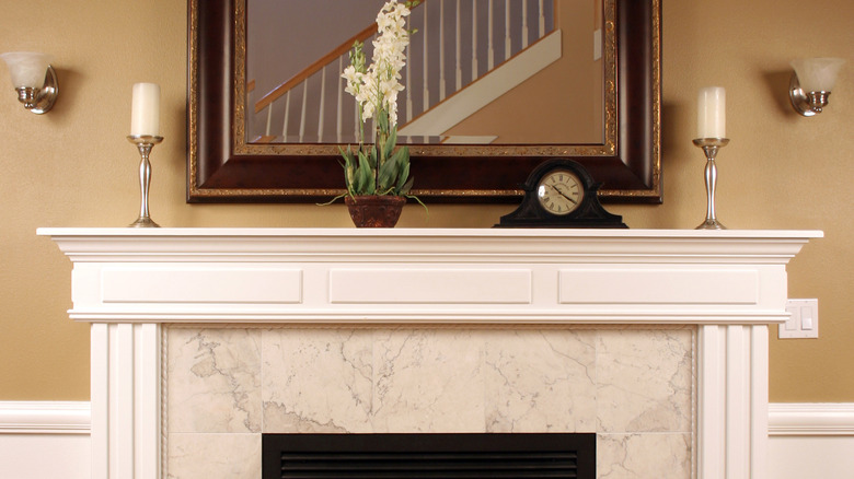 two wall sconces above mantel 