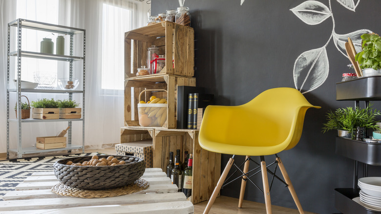 wood pallet shelves and yellow chair