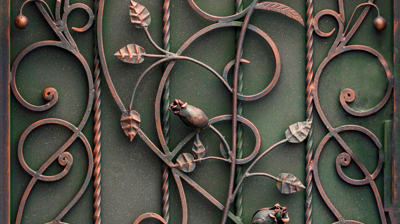wrought-iron wall art with leaves and flower buds