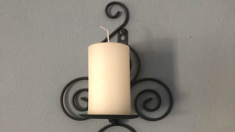wrought-iron sconces with a candle