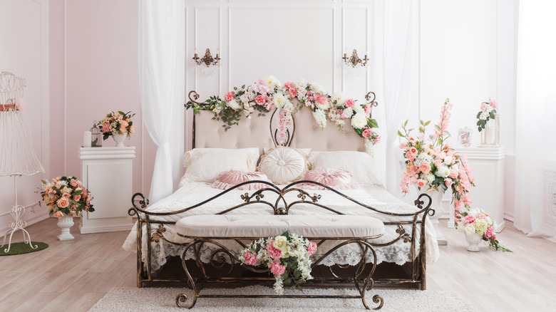 wrought-iron bed frame surrounded by flowers