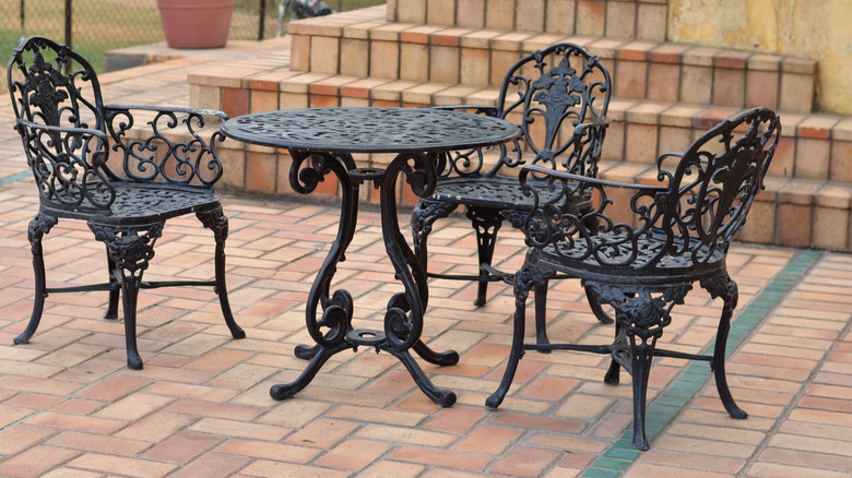 wrought-iron table and chairs on a brick patio